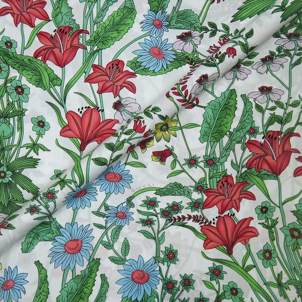 Floral fabric with red, blue, and green flowers on a white background