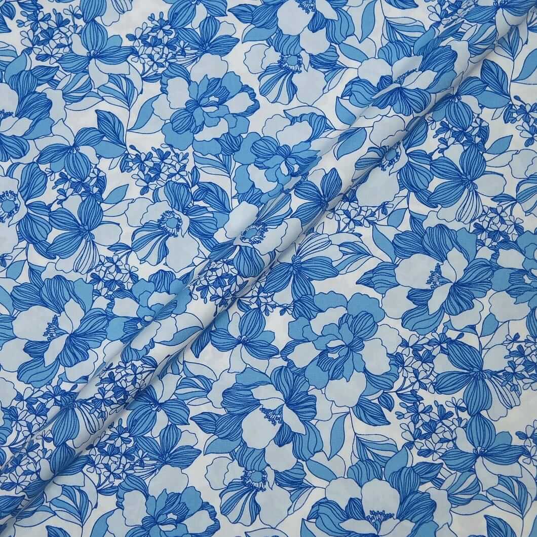 Blue floral pattern on white fabric