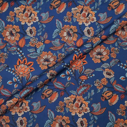 Floral patterned fabric with orange and blue colors on a blue background