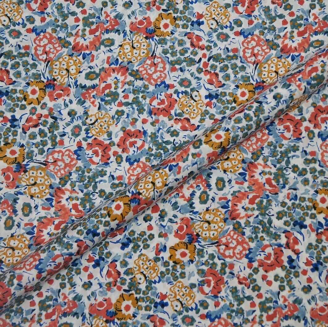 Floral fabric with a pattern of red, yellow, and blue flowers on a white background.
