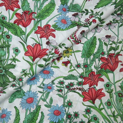 Floral fabric with red, blue, and green flowers on a white background