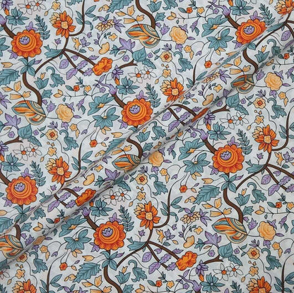 Floral patterned fabric with orange, blue, and green flowers on a white background