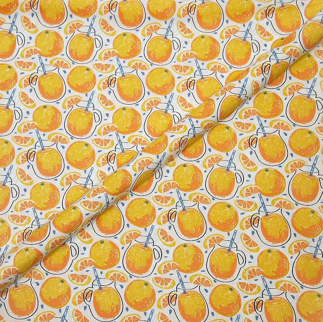 Patterned paper with orange juice design featuring cups, lemons, and straws on a white background.